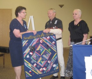 Westonka Whirlers Queen Elaine, the 2015 winner of the Edyth Beard Travelling Royalty Banner, received the banner from last year's winners from County Line Squares King Tony and Queen Gerlene.