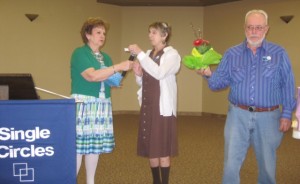 Door prizes awarded by the Mistress of Ceremonies Judy Willenbring, new Single Circles Queen Journey and past King Rick.