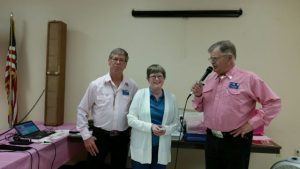 Caller Roger McNeil and President Harv Hegvick present Connie, a member of FM Breast Friends, a check for the proceeds of the 6th Annual Breast Cancer Awareness Benefit Dance.
